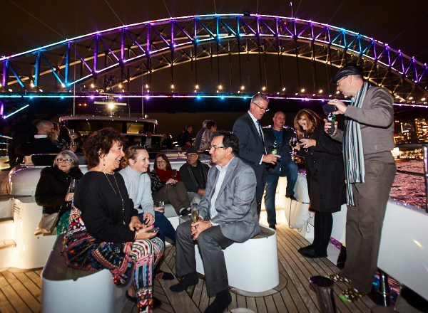 Guests socialising in front of Sydney Harbour Bridge