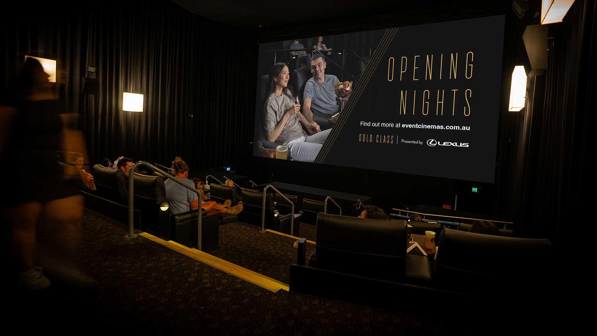 A room in a cinema with people sitting in the seats